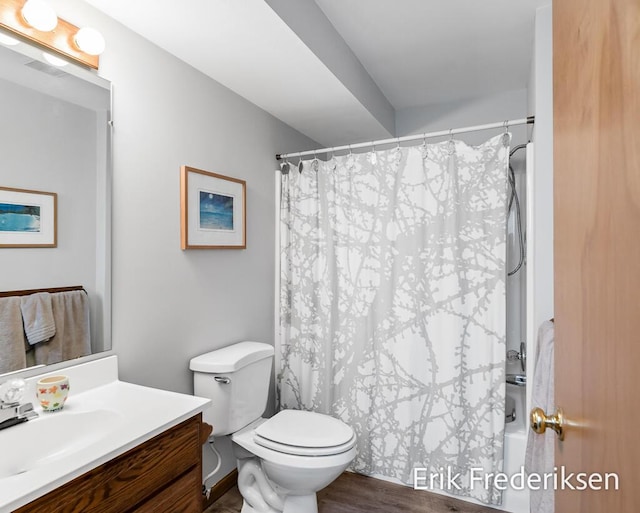 17879 Hidden Dunes Ln Unit D, Spring Lake, MI 49456 - bathroom with vanity, toilet, wood finished floors, and shower / tub combo with curtain