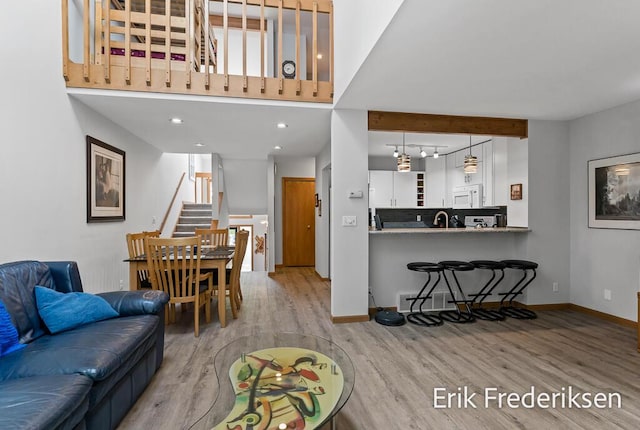17879 Hidden Dunes Ln Unit D, Spring Lake, MI 49456 - living area with wood finished floors, baseboards, stairway, and a high ceiling