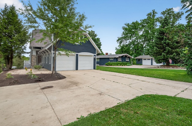 60757 Beechwood Ln, Cassopolis, MI 49031 - view of side of home featuring driveway, a yard, and an attached garage