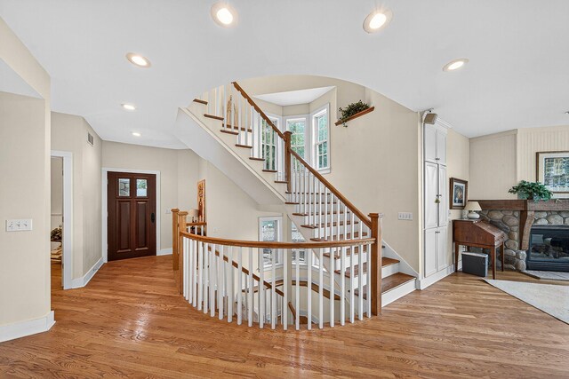 60757 Beechwood Ln, Cassopolis, MI 49031 - entrance foyer with wood finished floors, recessed lighting, stairway, arched walkways, and a stone fireplace