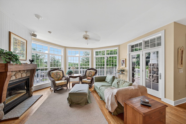 60757 Beechwood Ln, Cassopolis, MI 49031 - living room with light wood finished floors, a ceiling fan, and a fireplace