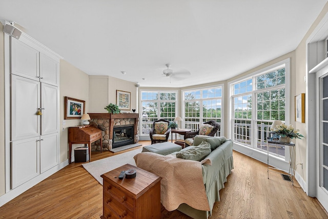 60757 Beechwood Ln, Cassopolis, MI 49031 - living area featuring a ceiling fan, light wood-style flooring, plenty of natural light, and a stone fireplace