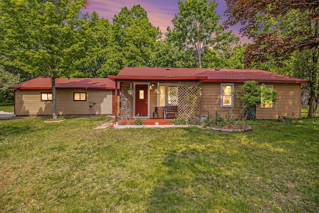 8424 3rd St, Onekama, MI 49675 - ranch-style home with a yard and a porch