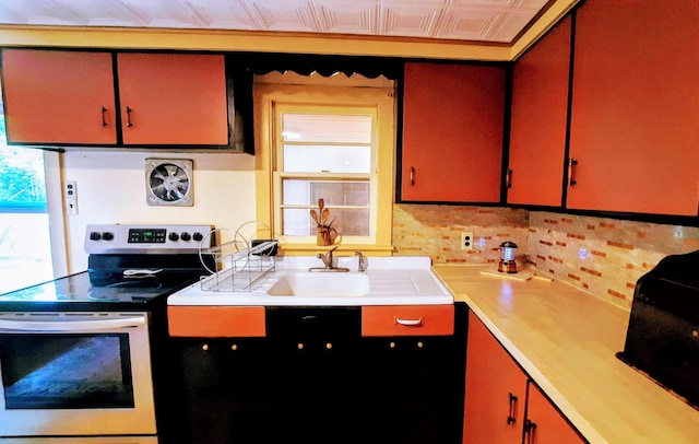 8424 3rd St, Onekama, MI 49675 - kitchen with stainless steel electric stove, plenty of natural light, and light countertops