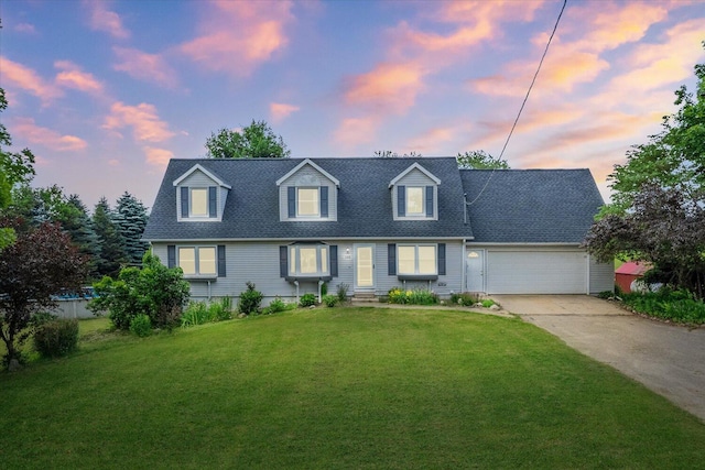 105 S Irving Rd, Hastings, MI 49058 - cape cod home featuring driveway, a garage, a lawn, and a shingled roof