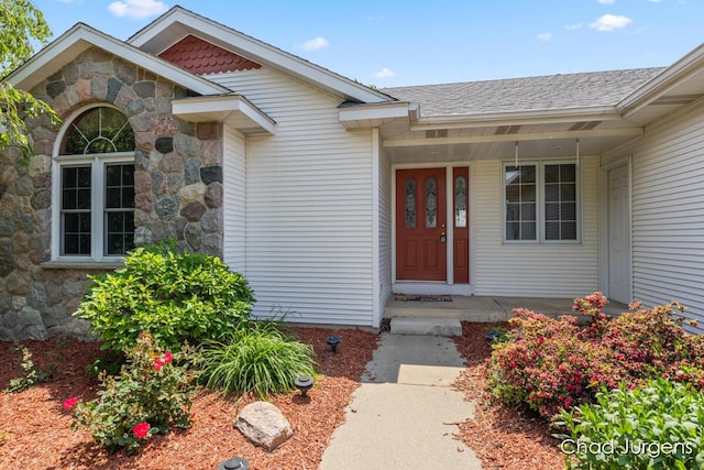 7564 Quincy St, Zeeland, MI 49464 - view of exterior entry with stone siding and roof with shingles