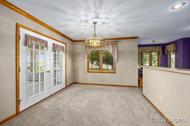 7564 Quincy St, Zeeland, MI 49464 - carpeted empty room featuring a chandelier, french doors, and ornamental molding