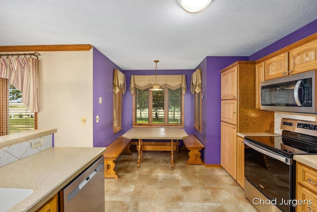 7564 Quincy St, Zeeland, MI 49464 - kitchen with appliances with stainless steel finishes, plenty of natural light, light countertops, and backsplash