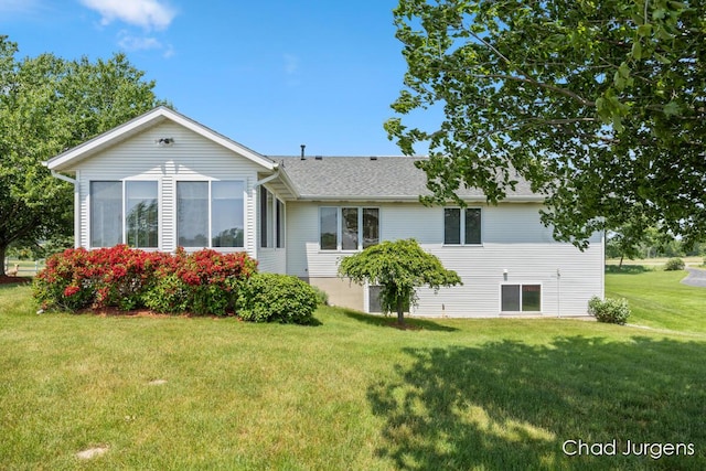 7564 Quincy St, Zeeland, MI 49464 - rear view of house featuring a yard and a shingled roof