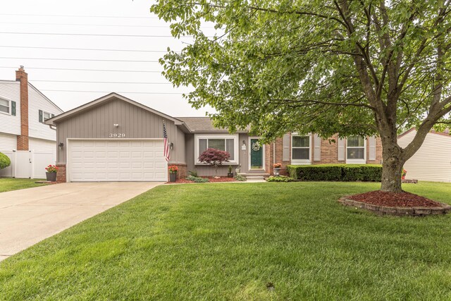 3929 Beech Dr, Ypsilanti, MI 48197 - view of front facade featuring a garage, brick siding, and driveway