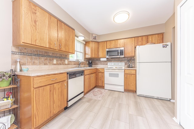 3929 Beech Dr, Ypsilanti, MI 48197 - kitchen with white appliances, light countertops, and decorative backsplash