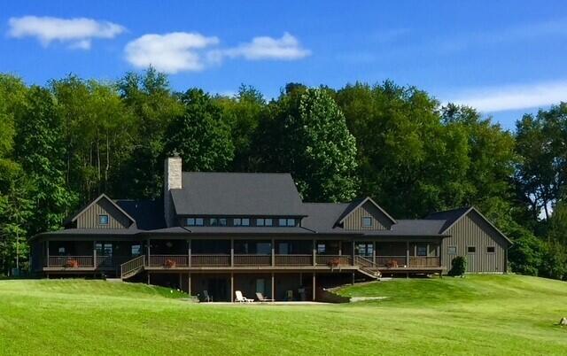 10258 Burgoyne Rd, Berrien Springs, MI 49103 - rear view of house featuring a yard, a deck, a chimney, and stairway