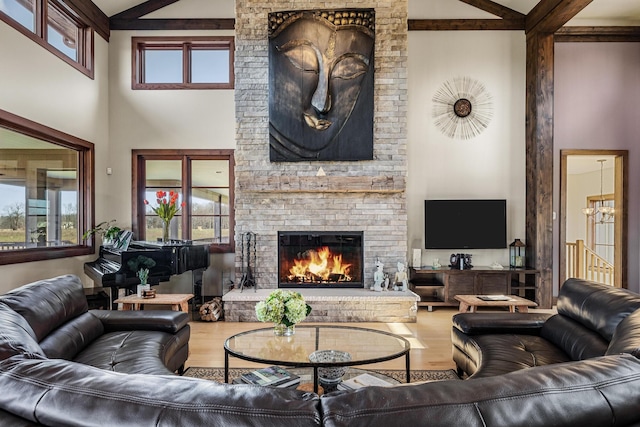 10258 Burgoyne Rd, Berrien Springs, MI 49103 - living room featuring a towering ceiling, a fireplace, wood finished floors, plenty of natural light, and beamed ceiling