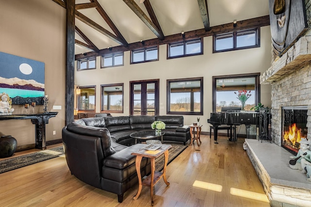 10258 Burgoyne Rd, Berrien Springs, MI 49103 - living room with high vaulted ceiling, a fireplace, plenty of natural light, beam ceiling, and wood finished floors
