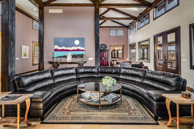 10258 Burgoyne Rd, Berrien Springs, MI 49103 - living area featuring a towering ceiling, beam ceiling, french doors, and wood finished floors