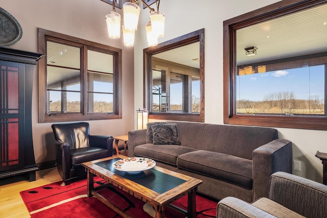 10258 Burgoyne Rd, Berrien Springs, MI 49103 - living area featuring a chandelier, wood finished floors, and plenty of natural light