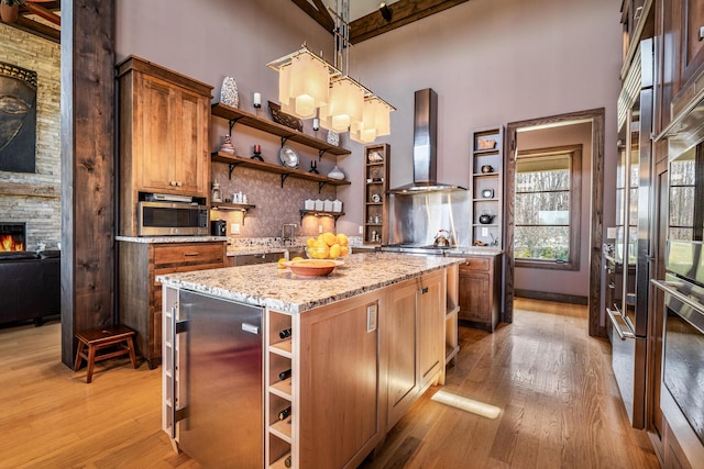 10258 Burgoyne Rd, Berrien Springs, MI 49103 - kitchen featuring open shelves, wall chimney exhaust hood, a high ceiling, appliances with stainless steel finishes, and light wood finished floors