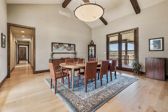 10258 Burgoyne Rd, Berrien Springs, MI 49103 - dining area with beam ceiling, light wood-type flooring, baseboards, high vaulted ceiling, and french doors