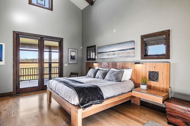 10258 Burgoyne Rd, Berrien Springs, MI 49103 - bedroom featuring high vaulted ceiling, access to outside, french doors, wood finished floors, and baseboards