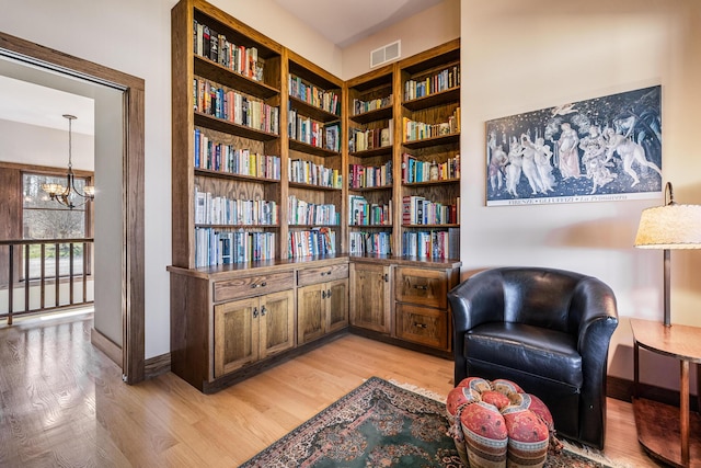 10258 Burgoyne Rd, Berrien Springs, MI 49103 - sitting room with light wood finished floors, a chandelier, and baseboards