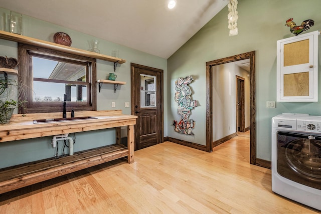 10258 Burgoyne Rd, Berrien Springs, MI 49103 - interior space with washer / clothes dryer, a sink, lofted ceiling, wood finished floors, and baseboards