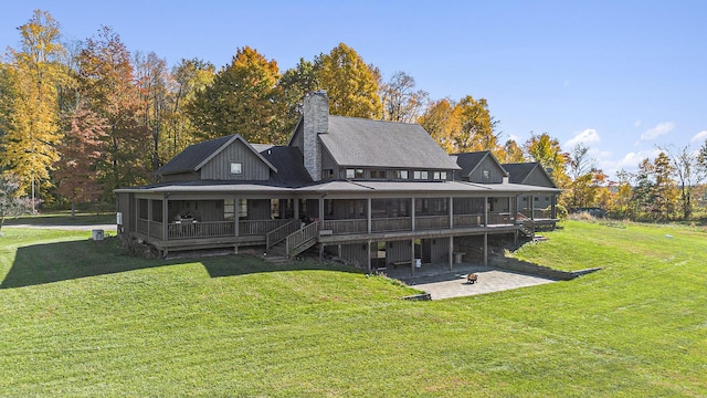 10258 Burgoyne Rd, Berrien Springs, MI 49103 - rear view of property with a lawn, a chimney, a patio area, and a sunroom