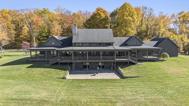 10258 Burgoyne Rd, Berrien Springs, MI 49103 - back of property featuring a patio area, a lawn, and a chimney
