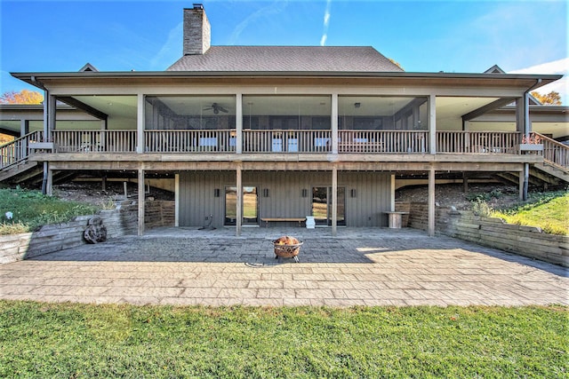 10258 Burgoyne Rd, Berrien Springs, MI 49103 - back of property with a sunroom, a patio area, an outdoor fire pit, and a chimney