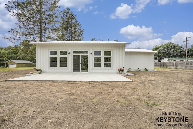 11012 Riverview Dr, Big Rapids, MI 49307 - back of house with a patio area and a metal roof