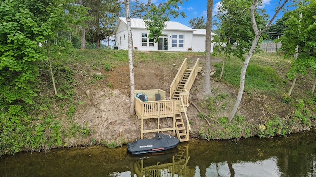 11012 Riverview Dr, Big Rapids, MI 49307 - rear view of house featuring stairs and a water view