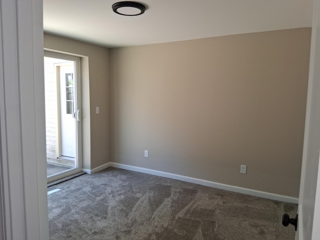 243 Lake Dr, Muskegon, MI 49441 - unfurnished room featuring dark carpet, healthy amount of natural light, and baseboards