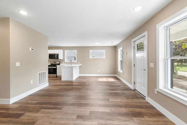 307 N Perrine St, Jackson, MI 49201 - unfurnished living room featuring wood finished floors and recessed lighting