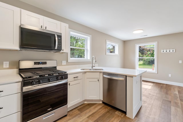 307 N Perrine St, Jackson, MI 49201 - kitchen with appliances with stainless steel finishes, light countertops, and healthy amount of natural light