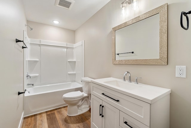 307 N Perrine St, Jackson, MI 49201 - full bath with wood finished floors, vanity, and shower / bath combination