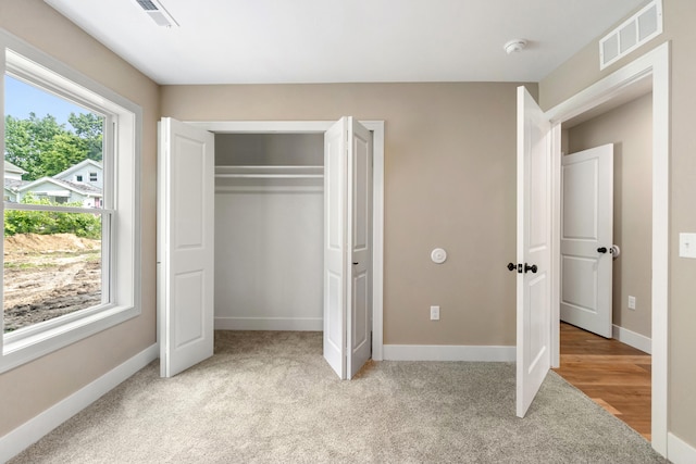 307 N Perrine St, Jackson, MI 49201 - unfurnished bedroom with light carpet and a closet