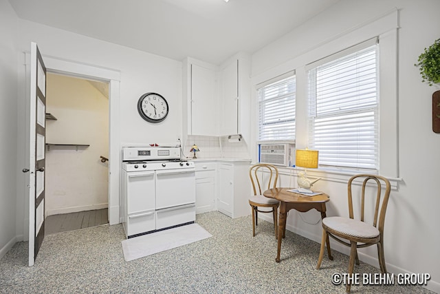 200 Richards Ave NW, Grand Rapids, MI 49504 - kitchen with gas range gas stove, white cabinets, cooling unit, light countertops, and backsplash
