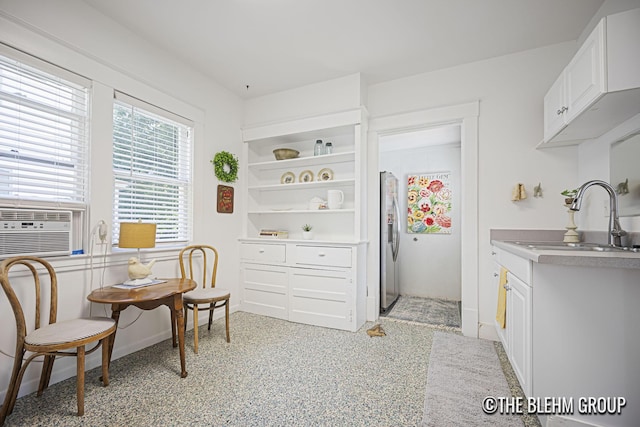 200 Richards Ave NW, Grand Rapids, MI 49504 - kitchen featuring stainless steel refrigerator with ice dispenser, white cabinetry, cooling unit, open shelves, and light countertops