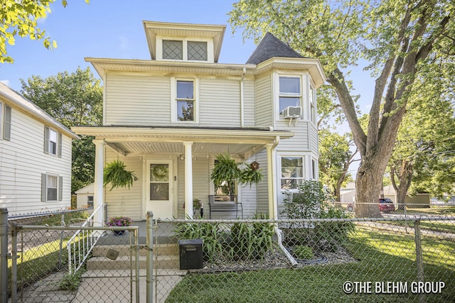 200 Richards Ave NW, Grand Rapids, MI 49504 - view of front of home with covered porch, a gate, a fenced front yard, and cooling unit