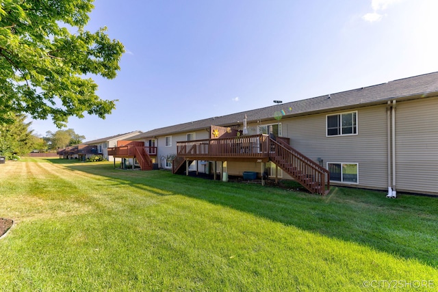 2883 Harmony Ct, Wyoming, MI 49519 - rear view of property with stairway, a deck, and a lawn