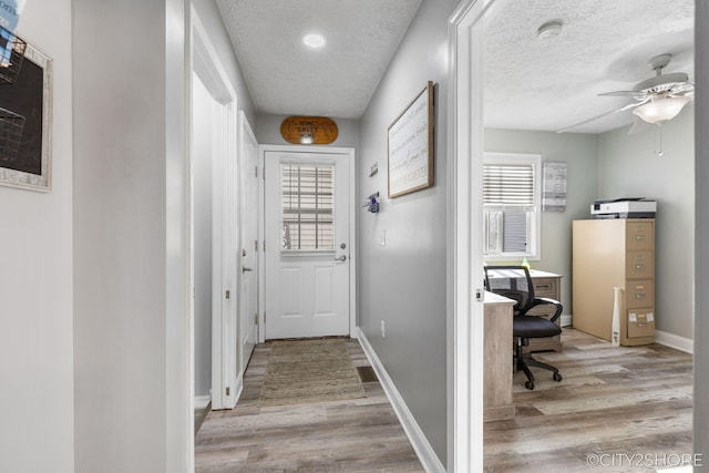 2883 Harmony Ct, Wyoming, MI 49519 - doorway to outside with a desk, light wood finished floors, a ceiling fan, plenty of natural light, and a textured ceiling