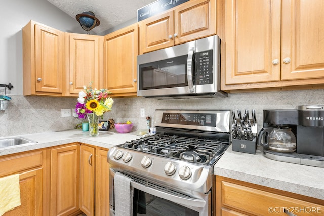 2883 Harmony Ct, Wyoming, MI 49519 - kitchen with stainless steel appliances, light countertops, backsplash, and a textured ceiling