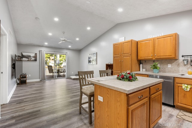 2883 Harmony Ct, Wyoming, MI 49519 - kitchen featuring stainless steel dishwasher, a ceiling fan, light countertops, a kitchen island, and light wood finished floors