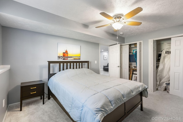 2883 Harmony Ct, Wyoming, MI 49519 - carpeted bedroom featuring multiple closets, a textured ceiling, a ceiling fan, and baseboards