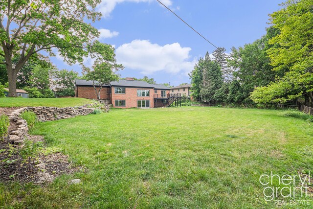 1757 Westlane Dr NE, Grand Rapids, MI 49505 - view of yard with stairs and a wooden deck