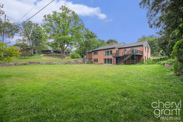 1757 Westlane Dr NE, Grand Rapids, MI 49505 - view of grassy yard with stairs and a wooden deck