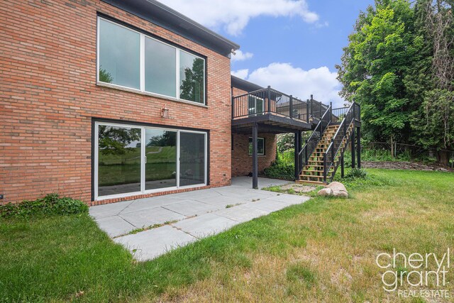 1757 Westlane Dr NE, Grand Rapids, MI 49505 - rear view of property featuring stairway, a deck, a patio, and brick siding
