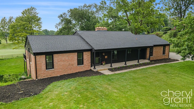 1757 Westlane Dr NE, Grand Rapids, MI 49505 - view of front of property featuring a chimney, brick siding, a shingled roof, and a front lawn