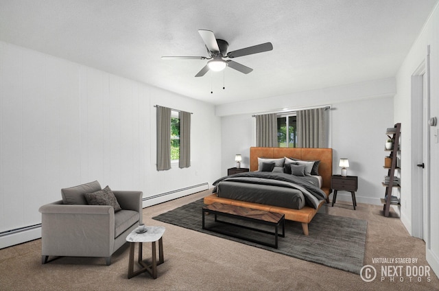 1757 Westlane Dr NE, Grand Rapids, MI 49505 - carpeted bedroom with a baseboard heating unit and a ceiling fan
