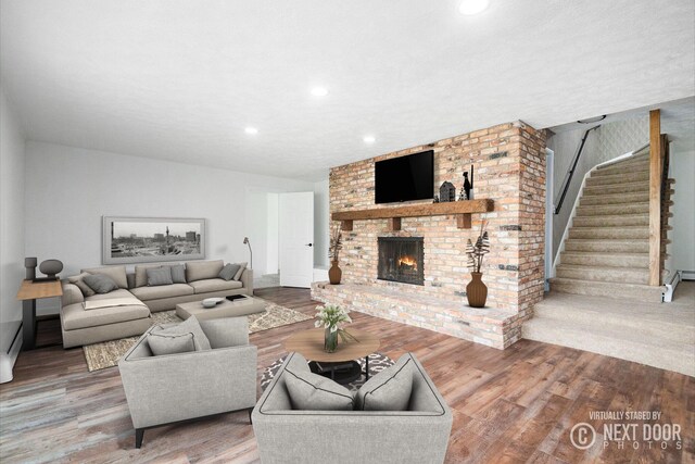 1757 Westlane Dr NE, Grand Rapids, MI 49505 - living area with stairway, a brick fireplace, wood finished floors, and recessed lighting