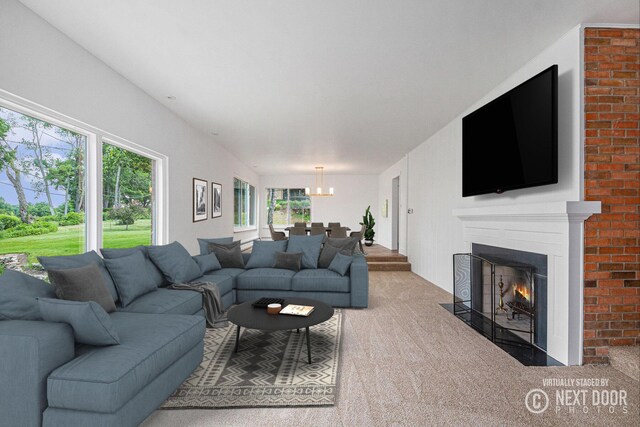 1757 Westlane Dr NE, Grand Rapids, MI 49505 - living area featuring carpet flooring, a chandelier, and a fireplace with flush hearth